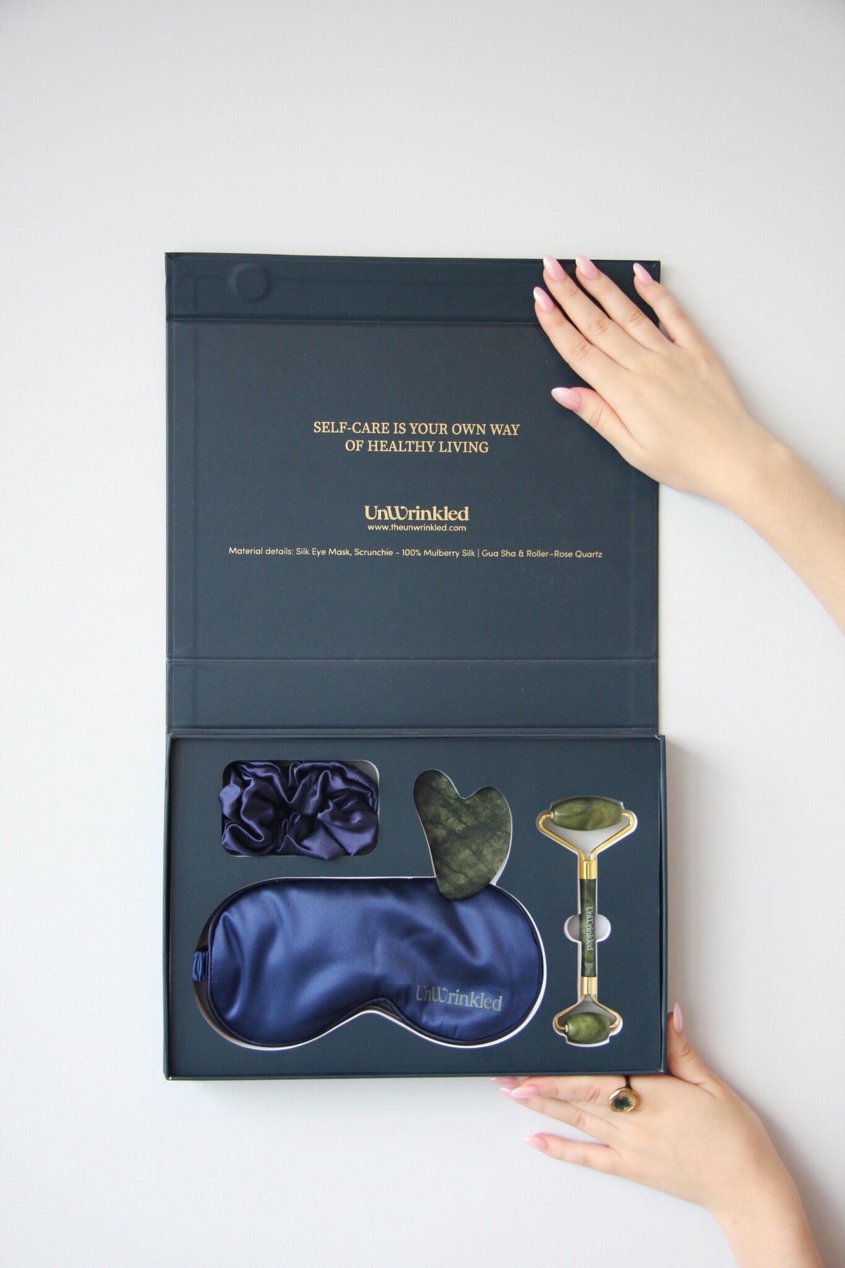 Midnight Calm box open: blue silk eye mask, scrunchie, jade gua sha and roller