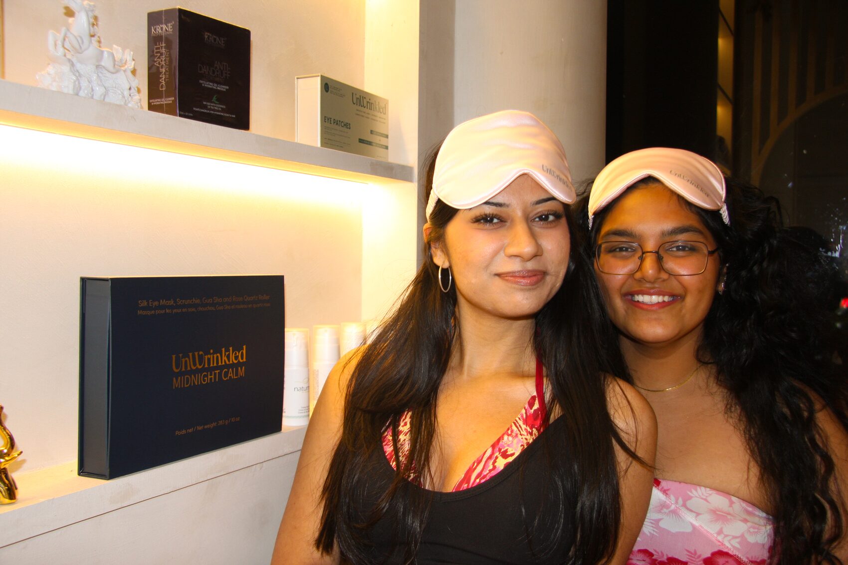 Two friends in silk eye masks, side by side